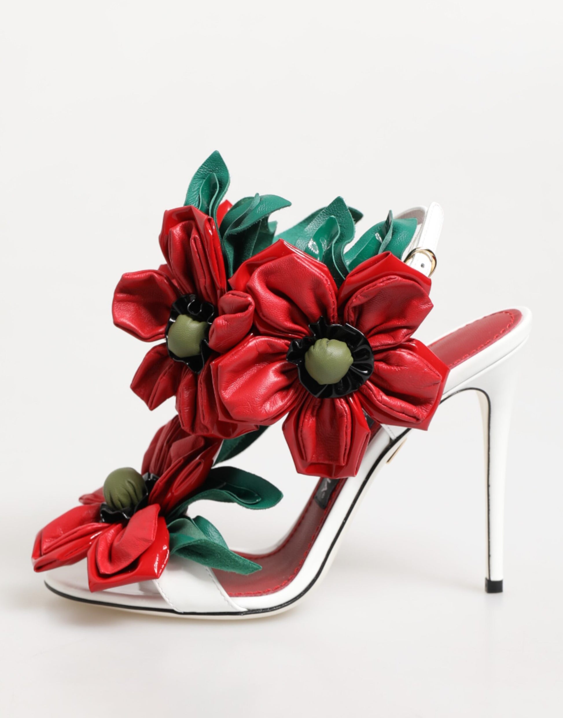 High-heeled shoe with red floral design on a white background