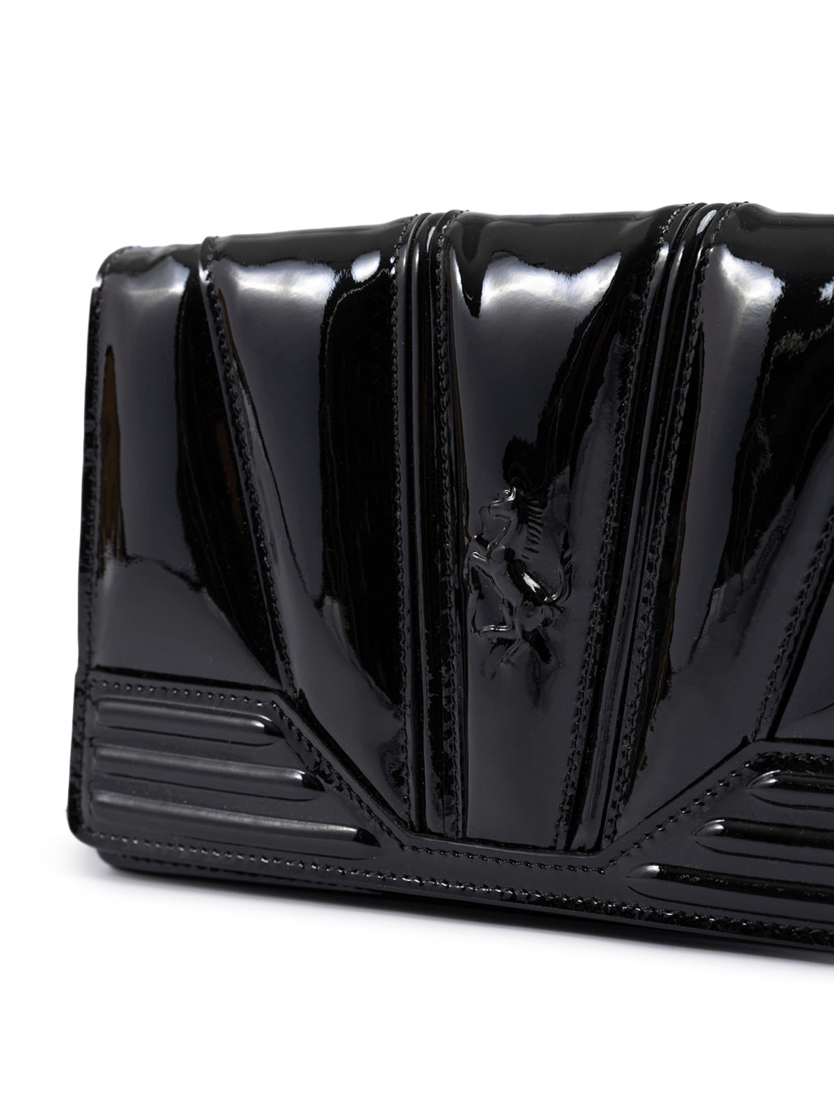 Black patent leather handbag on a white background