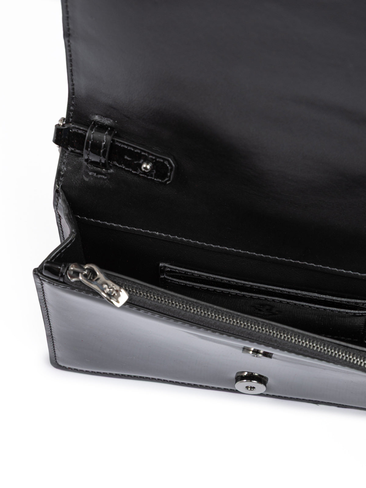 Close-up of a black leather handbag with a zipper on a white background