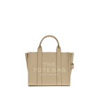 Beige tote bag with 'The Tote Bag' and 'Marc Jacobs' text on a white background