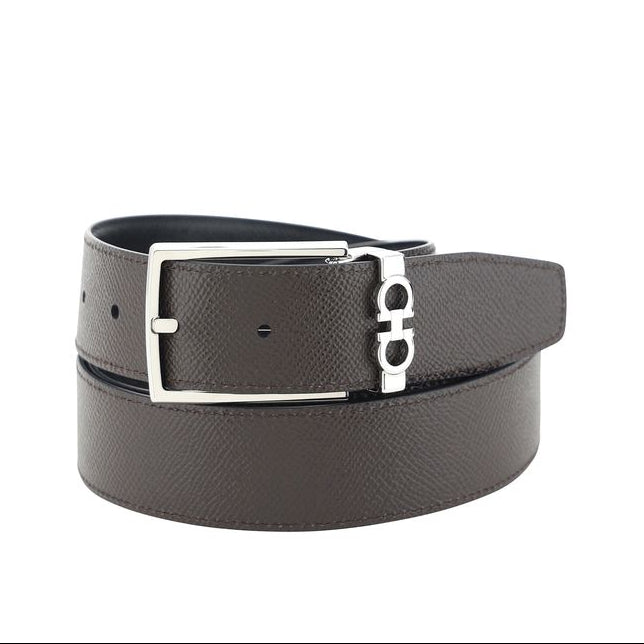 Black leather belt with silver buckle on a white background
