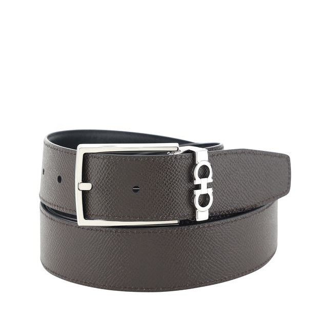 Black leather belt with silver buckle on a white background