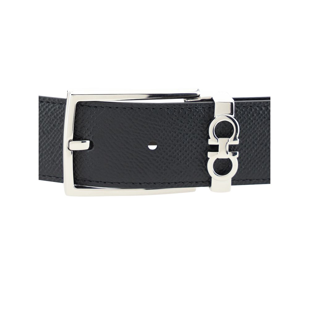 Black leather belt with silver buckle on a white background