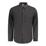 A black, long-sleeved Calvin Klein shirt with a classic fit and a button-up front. It features a left chest pocket, Italian collar, and 2-button cuffs.