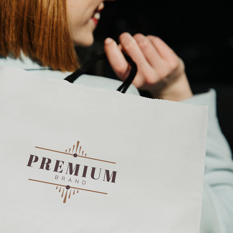 Person holding a white bag with 'PREMIUM BRAND' logo Zachava