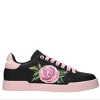 Black sneaker with pink floral design and pink accents on a white background